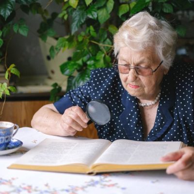 Older woman with magnifying glass